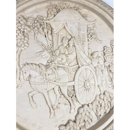 514 - A Chinese resin circular wall plaque depicting a horse and carriage - approx. 50cm diameter