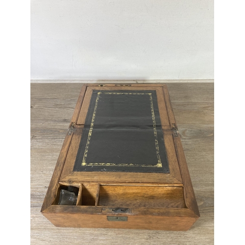 520 - A late 19th/early 20th century oak writing slope with black leather insert - approx. 16cm high x 30c... 