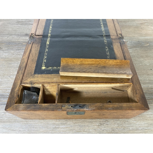 520 - A late 19th/early 20th century oak writing slope with black leather insert - approx. 16cm high x 30c... 