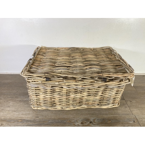 522 - A wicker twin handled basket - approx. 26cm high x 55cm wide x 39cm deep