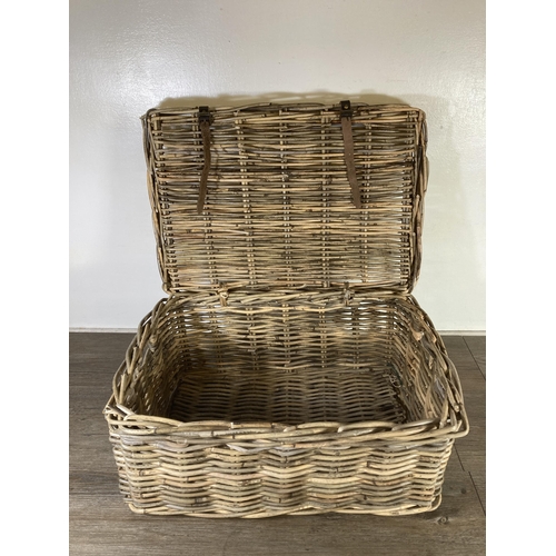 522 - A wicker twin handled basket - approx. 26cm high x 55cm wide x 39cm deep