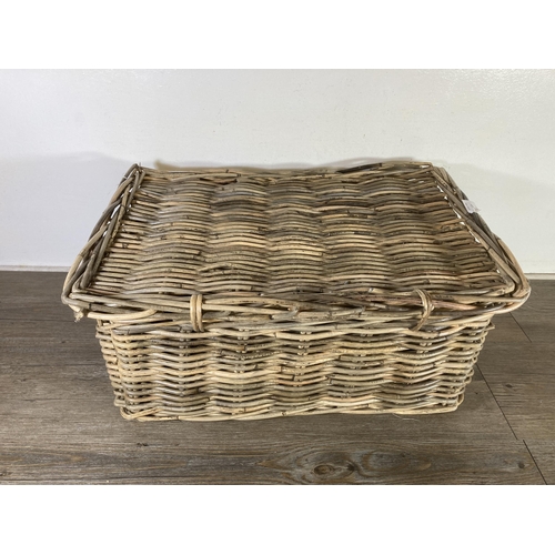 522 - A wicker twin handled basket - approx. 26cm high x 55cm wide x 39cm deep