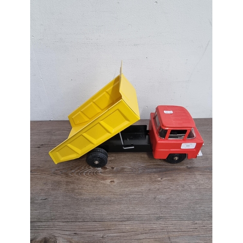 331 - Two vintage painted metal toy construction vehicles one Louis Marx & Co. dumper truck and one crane