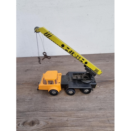 331 - Two vintage painted metal toy construction vehicles one Louis Marx & Co. dumper truck and one crane