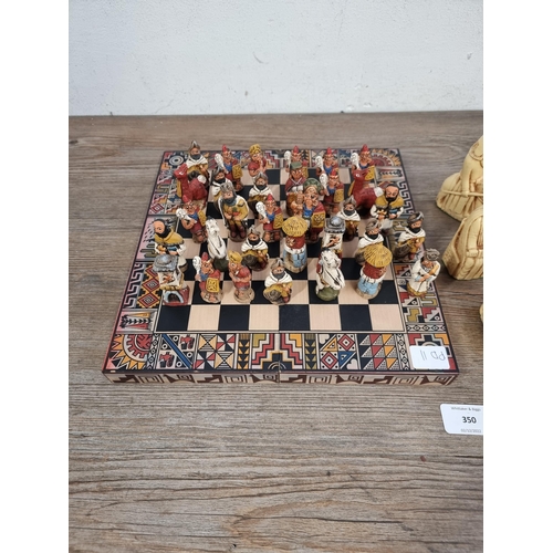 350 - Two chess sets, one black and cream resin Isle of Lewis and one South American style with storage bo... 