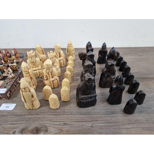 350 - Two chess sets, one black and cream resin Isle of Lewis and one South American style with storage bo... 