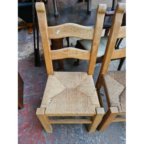 68A - A pair of beech cottage style dining chairs with rush seats