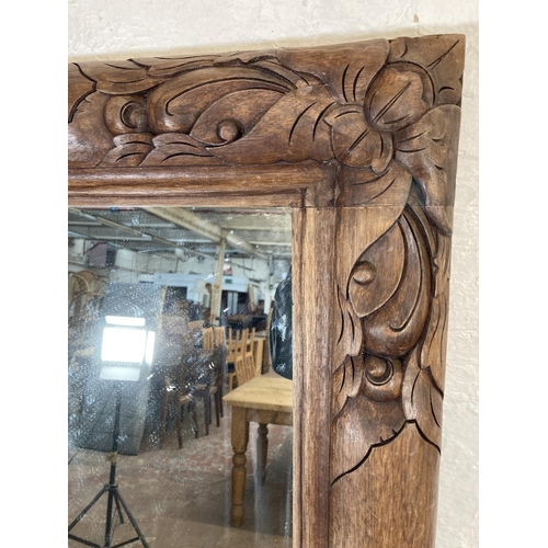 149C - A large modern carved teak framed wall mirror - approx. 160cm x 95cm