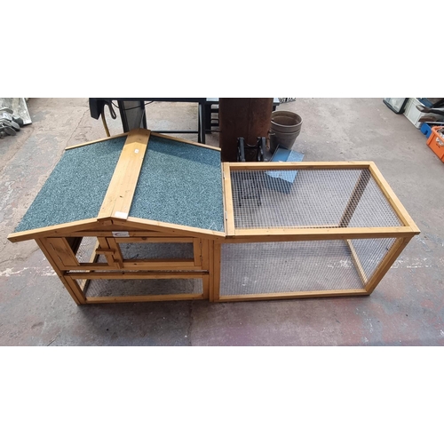 642 - A Bunny Business pine rabbit hutch - approx. 68cm high x 58cm deep x 156cm long