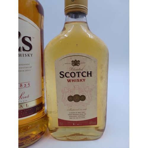 557 - Three bottles of blended Scotch whisky, one 70cl Bell's - bottled at 40%, one 35cl Asda - bottled at... 