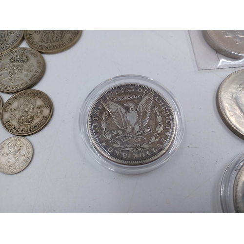 1230 - A collection of coins to include 90% silver American 1883 'Morgan' dollar, four 50% silver half crow... 