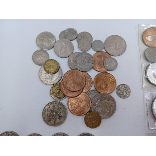 1230 - A collection of coins to include 90% silver American 1883 'Morgan' dollar, four 50% silver half crow... 