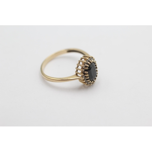 1004 - A 9ct gold sapphire and diamond halo dress ring, size N½ - approx. gross weight 1.8 grams