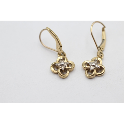 1008 - A pair of 10ct gold diamond set floral drop earrings - approx. gross weight 2.1 grams