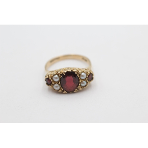 1023 - A 9ct gold garnet and pearl ornate gypsy setting ring, size N½ - approx. gross weight 4.1 grams