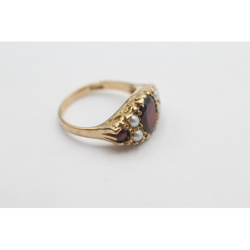 1023 - A 9ct gold garnet and pearl ornate gypsy setting ring, size N½ - approx. gross weight 4.1 grams