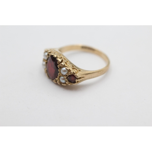 1023 - A 9ct gold garnet and pearl ornate gypsy setting ring, size N½ - approx. gross weight 4.1 grams