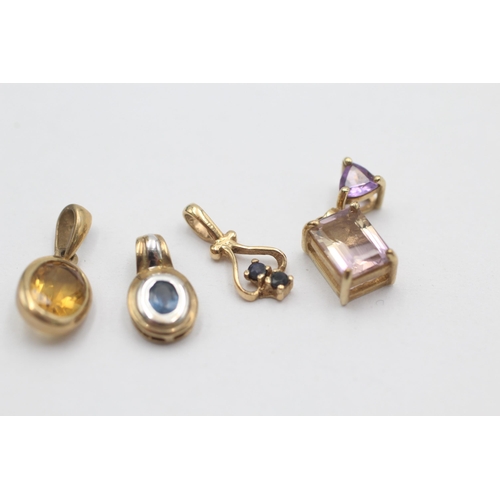 1027 - Four 9ct gold gemstone set pendants, two sapphire, one ametrine and one citrine - approx. gross weig... 