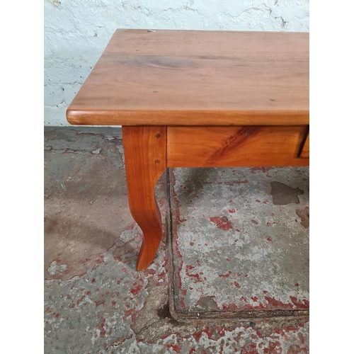 106 - An Indian style cherry wood rectangular coffee table with single drawer - approx. 40cm high x 58cm w... 