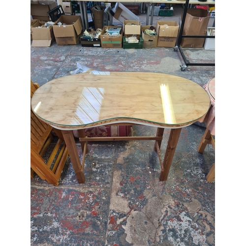 137 - Two pine and glass top kidney shaped dressing tables