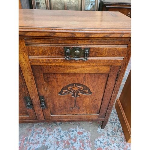 10 - An Art Nouveau carved oak sideboard with two drawers and two cupboard doors - approx. 93cm high x 12... 