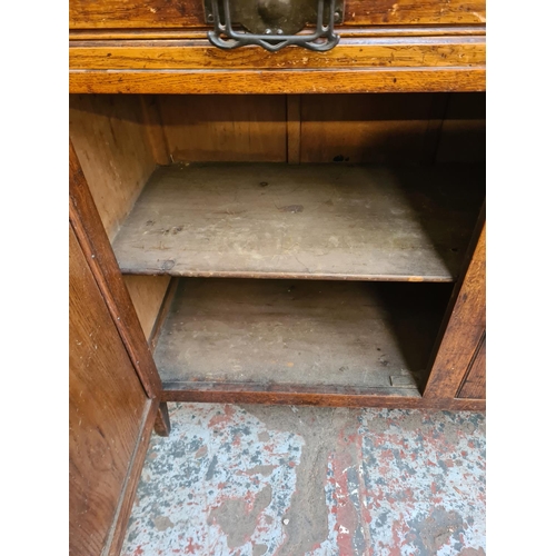 10 - An Art Nouveau carved oak sideboard with two drawers and two cupboard doors - approx. 93cm high x 12... 