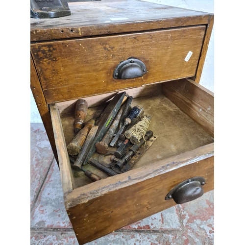 100 - An early/mid 20th century pine tools cabinet containing vintage hand tools and mounted with cast iro... 