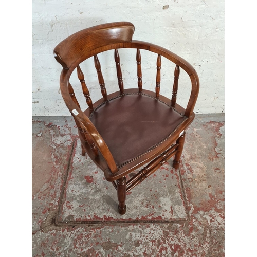 107 - An elm and beech desk chair with brown leatherette upholstery - approx. 81cm high x 55cm wide x 45cm... 