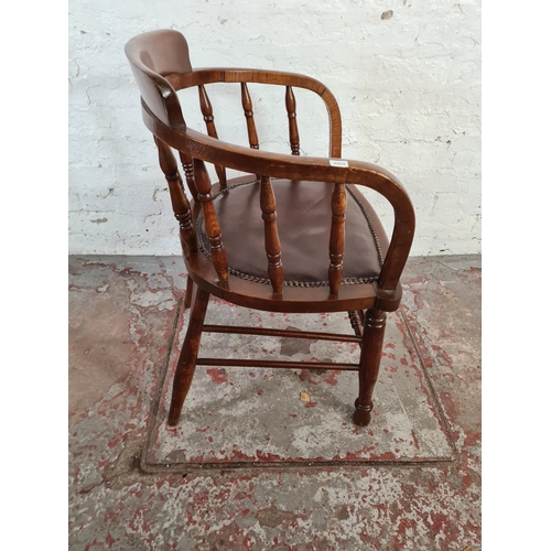 107 - An elm and beech desk chair with brown leatherette upholstery - approx. 81cm high x 55cm wide x 45cm... 