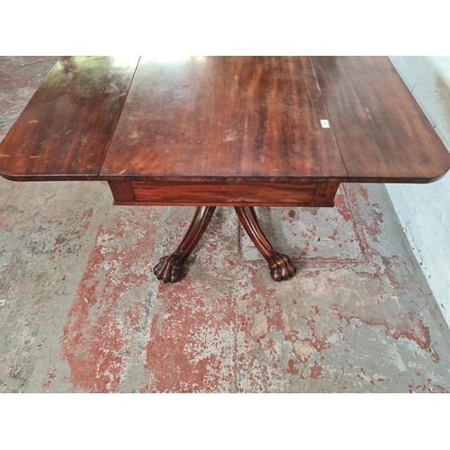 108 - A 19th century mahogany drop leaf dining table with four carved lion paw supports - approx. 73cm hig... 