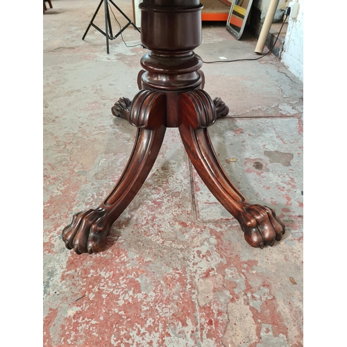 108 - A 19th century mahogany drop leaf dining table with four carved lion paw supports - approx. 73cm hig... 