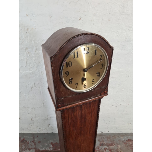 115 - A 1930s oak cased chiming granddaughter clock with pendulum - approx. 130cm high