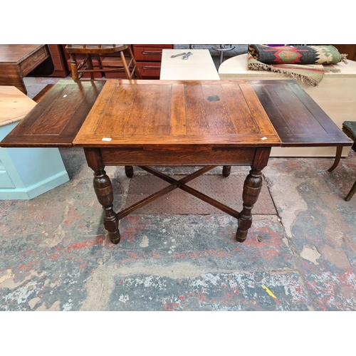 119 - A 1930s oak rectangular draw leaf dining table with baluster supports - approx. 75cm high x 76cm wid... 