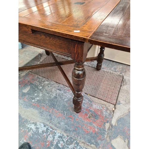 119 - A 1930s oak rectangular draw leaf dining table with baluster supports - approx. 75cm high x 76cm wid... 