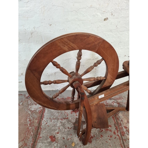 133 - A 19th century style beech spinning wheel - approx. 85cm high