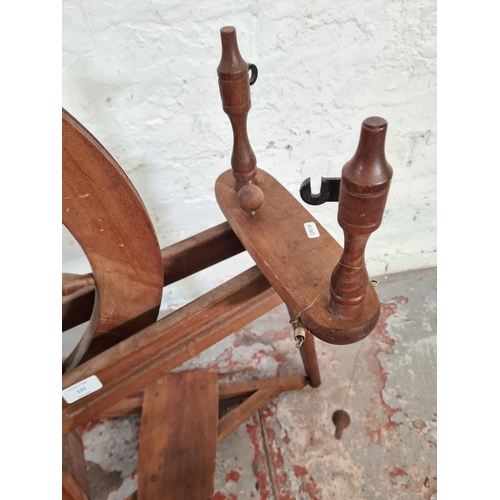 133 - A 19th century style beech spinning wheel - approx. 85cm high