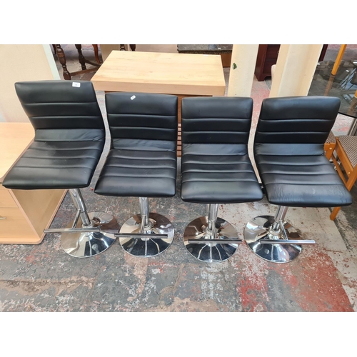 136 - Four modern black leatherette and chrome plated kitchen bar stools