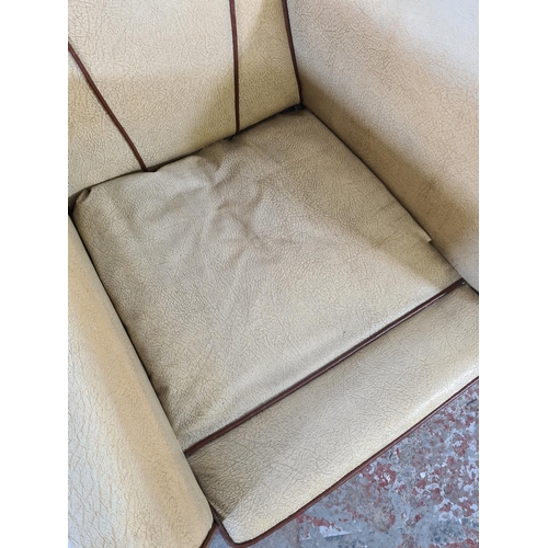 16 - An Art Deco brown and beige vinyl upholstered fan back armchair