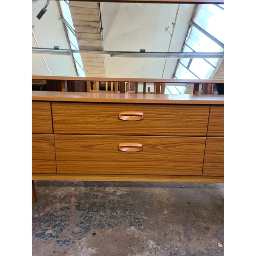 19 - A Schreiber teak effect dressing table with six drawers and upper mirror - approx. 119cm high x 152c... 