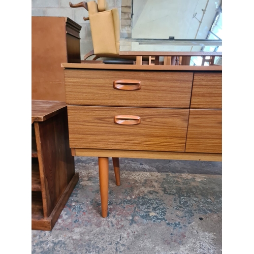 19 - A Schreiber teak effect dressing table with six drawers and upper mirror - approx. 119cm high x 152c... 