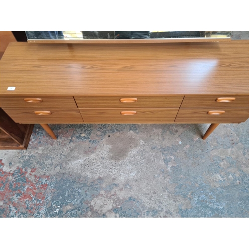 19 - A Schreiber teak effect dressing table with six drawers and upper mirror - approx. 119cm high x 152c... 