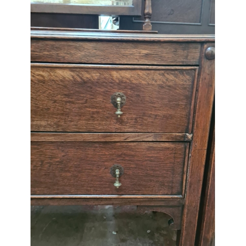 22 - A 1930s oak dressing table with upper bevelled edge mirror and two drawers - approx. 156cm high x 99... 