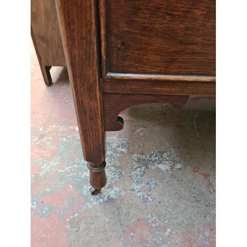 22 - A 1930s oak dressing table with upper bevelled edge mirror and two drawers - approx. 156cm high x 99... 