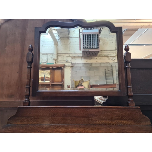 22 - A 1930s oak dressing table with upper bevelled edge mirror and two drawers - approx. 156cm high x 99... 