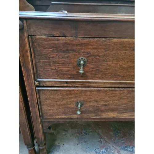 23 - A 1930s oak chest of two drawers - approx. 88cm high x 91cm wide x 48cm deep