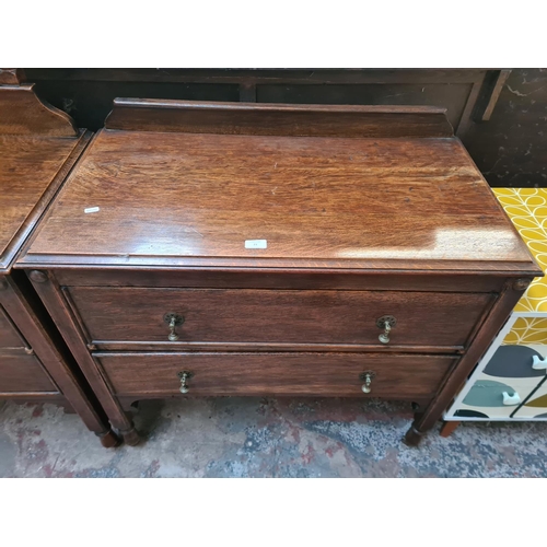 23 - A 1930s oak chest of two drawers - approx. 88cm high x 91cm wide x 48cm deep