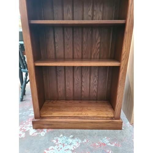 27 - An oak seven tier freestanding bookcase - approx. 200cm high x 81cm wide x 34cm deep