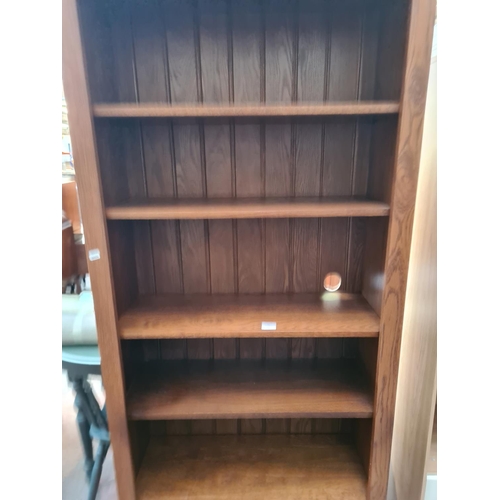 27 - An oak seven tier freestanding bookcase - approx. 200cm high x 81cm wide x 34cm deep