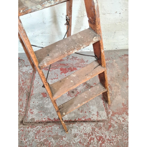 30 - An antique Simplex pine and metal five tread stepladder - approx. 102cm high