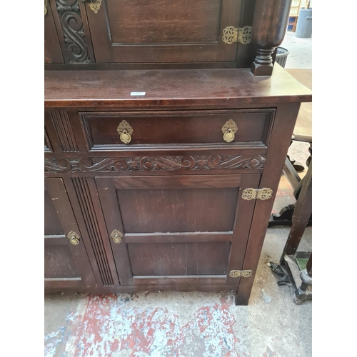 31 - A 17th century style carved oak court cupboard - approx. 151cm high x 137cm wide x 48cm deep